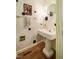 Charming powder room featuring a pedestal sink, decorative mirror, and gold accents at 910 Old Orchard Rd, Chapel Hill, NC 27517