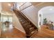 Grand staircase leading to the upper level with hardwood floors and natural light at 910 Old Orchard Rd, Chapel Hill, NC 27517