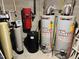 Hot water system including water heater tanks, filters, and water softener at 910 Old Orchard Rd, Chapel Hill, NC 27517