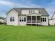 Back exterior of a two-story house with a screened porch and a well-maintained lawn at 921 Lily Claire Ln, Fuquay Varina, NC 27526