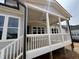 Covered back porch with ceiling fan offers a cool, relaxing outdoor space with views of the home's exterior at 921 Lily Claire Ln, Fuquay Varina, NC 27526