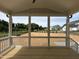 Back porch featuring exposed stained wooden floors with a stunning view of the expansive green space behind the home at 921 Lily Claire Ln, Fuquay Varina, NC 27526