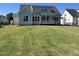 Spacious backyard featuring a newly installed lawn, and a view of the rear exterior and porch of the house at 921 Lily Claire Ln, Fuquay Varina, NC 27526