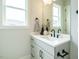 Bathroom with white vanity, framed mirror, and black fixtures at 921 Lily Claire Ln, Fuquay Varina, NC 27526