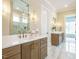 Bathroom with double sinks, decorative lighting, large mirror and walk in shower at 921 Lily Claire Ln, Fuquay Varina, NC 27526