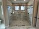 Luxurious glass enclosed shower in a bathroom featuring tile and modern fixtures at 921 Lily Claire Ln, Fuquay Varina, NC 27526