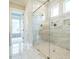 Bathroom featuring elegant glass shower with marble tile and built-in niche at 921 Lily Claire Ln, Fuquay Varina, NC 27526
