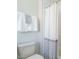 Neutral bathroom with white subway tile shower, white fixtures and gray and white striped accents at 921 Lily Claire Ln, Fuquay Varina, NC 27526