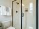 Modern bathroom featuring a glass-enclosed shower with white chevron tile and matte black hardware at 921 Lily Claire Ln, Fuquay Varina, NC 27526