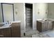 Bathroom with double vanity, sconces, and a doorway to a walk-in closet at 921 Lily Claire Ln, Fuquay Varina, NC 27526