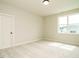 Light-filled bedroom with plush carpet, a large window, and a neutral color palette at 921 Lily Claire Ln, Fuquay Varina, NC 27526