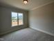 Bright bedroom featuring a large window that offers exterior views and fills the space with natural light at 921 Lily Claire Ln, Fuquay Varina, NC 27526