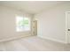 Bright bedroom with neutral carpet, a large window, and white trim throughout at 921 Lily Claire Ln, Fuquay Varina, NC 27526