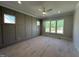 Large bedroom featuring a board and batten accent wall and natural light from the windows at 921 Lily Claire Ln, Fuquay Varina, NC 27526