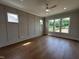 Spacious bedroom featuring wood floors, a ceiling fan, recessed lighting, and plenty of windows at 921 Lily Claire Ln, Fuquay Varina, NC 27526