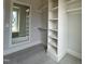 A closet with built-in shelving and a mirror on the wall that gives the space depth and makes it seem bigger at 921 Lily Claire Ln, Fuquay Varina, NC 27526