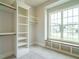 Walk-in closet with custom shelving and bench seat at 921 Lily Claire Ln, Fuquay Varina, NC 27526
