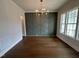 Bright dining room boasts wood floors, decorative chandelier, and a stylish accent wall at 921 Lily Claire Ln, Fuquay Varina, NC 27526