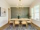 Elegant dining area featuring modern lighting, decorative accent wall, and ample natural light at 921 Lily Claire Ln, Fuquay Varina, NC 27526