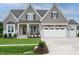 Charming two-story home with a beautifully landscaped front yard and a three-car garage at 921 Lily Claire Ln, Fuquay Varina, NC 27526
