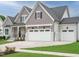 Beautifully landscaped two-story home featuring a three-car garage and welcoming curb appeal at 921 Lily Claire Ln, Fuquay Varina, NC 27526
