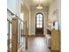 Welcoming foyer featuring hardwood floors, elegant lighting, and a stylish wooden door at 921 Lily Claire Ln, Fuquay Varina, NC 27526