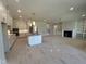 Spacious kitchen with island, modern appliances, and an open layout to the living room at 921 Lily Claire Ln, Fuquay Varina, NC 27526