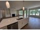 Bright kitchen with stainless steel appliances and a center island that opens to a living space at 921 Lily Claire Ln, Fuquay Varina, NC 27526