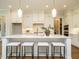 Modern kitchen featuring an island with seating, pendant lighting, and white cabinetry at 921 Lily Claire Ln, Fuquay Varina, NC 27526