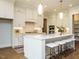 Bright, modern kitchen featuring an island with seating, ample counter space, and white cabinets at 921 Lily Claire Ln, Fuquay Varina, NC 27526