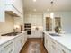 Bright kitchen featuring stainless appliances, white cabinets, and large island with sink at 921 Lily Claire Ln, Fuquay Varina, NC 27526