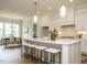 Spacious kitchen featuring a large island, pendant lights, and modern stainless steel appliances at 921 Lily Claire Ln, Fuquay Varina, NC 27526