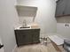 Laundry room features gray cabinets, sink, and plenty of storage space at 921 Lily Claire Ln, Fuquay Varina, NC 27526