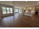 Open concept kitchen, living room and dining room with wood floors and lots of natural light at 921 Lily Claire Ln, Fuquay Varina, NC 27526