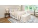 Cozy bedroom with plush bedding, bedside tables, accent rug and plenty of light from the windows at 921 Lily Claire Ln, Fuquay Varina, NC 27526