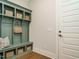 A mudroom has a built-in bench with storage cubbies, providing practical space for organization and entry at 921 Lily Claire Ln, Fuquay Varina, NC 27526
