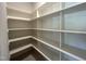 Spacious pantry features open shelving for optimal storage and organization at 921 Lily Claire Ln, Fuquay Varina, NC 27526