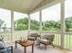 Relax on the screened porch with views of the yard, comfortable seating, and a wooden coffee table at 921 Lily Claire Ln, Fuquay Varina, NC 27526