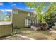 Backyard featuring a two story home, partial fence, and a small deck at 9332 Leslieshire Dr, Raleigh, NC 27615