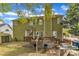 Backyard featuring an outdoor dining area with grill, steps to a wooden deck, and mature trees at 9332 Leslieshire Dr, Raleigh, NC 27615