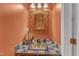 Charming bathroom with decorative mirror, uniquely tiled sink, and a warm, inviting ambiance at 9332 Leslieshire Dr, Raleigh, NC 27615