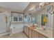 Traditional bathroom with a soaking tub, double vanity, walk-in shower, and decorative wallpaper at 9332 Leslieshire Dr, Raleigh, NC 27615