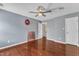 This bedroom offers a ceiling fan, hardwood floors, neutral paint, and natural light at 9332 Leslieshire Dr, Raleigh, NC 27615