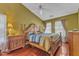 Comfortable bedroom with high ceilings, a ceiling fan, and a large bed with decorative pillows at 9332 Leslieshire Dr, Raleigh, NC 27615