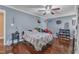 This bedroom features a ceiling fan, hardwood floors, and natural light at 9332 Leslieshire Dr, Raleigh, NC 27615