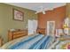 Spacious bedroom featuring unique wall colors, a large bed, and a glimpse into an ensuite bathroom at 9332 Leslieshire Dr, Raleigh, NC 27615