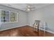 Minimalist bedroom with hardwood floors, ample natural light, and simple furniture for a serene atmosphere at 9332 Leslieshire Dr, Raleigh, NC 27615