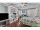This bedroom offers a ceiling fan, hardwood floors, natural light, and built-in shelving at 9332 Leslieshire Dr, Raleigh, NC 27615