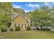 Charming two-story home with a well-manicured lawn and mature trees, creating a welcoming curb appeal at 9332 Leslieshire Dr, Raleigh, NC 27615