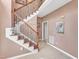 A warm, inviting foyer showcases a staircase with iron spindles and wood handrails, complemented by neutral wall colors at 9332 Leslieshire Dr, Raleigh, NC 27615